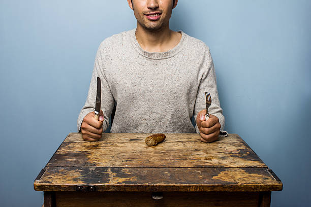 istock Man about to eat sausage 471769681