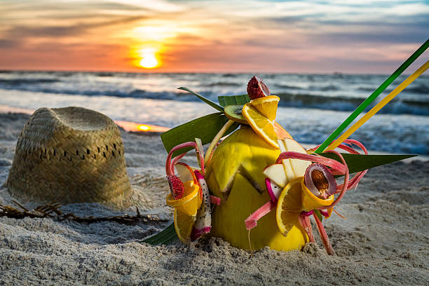 istock Closeup of fruit cocktail on the beach at sunset 471770595
