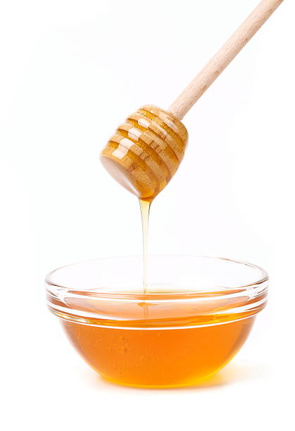 istock Bee honey with wooden dipper. 471770911