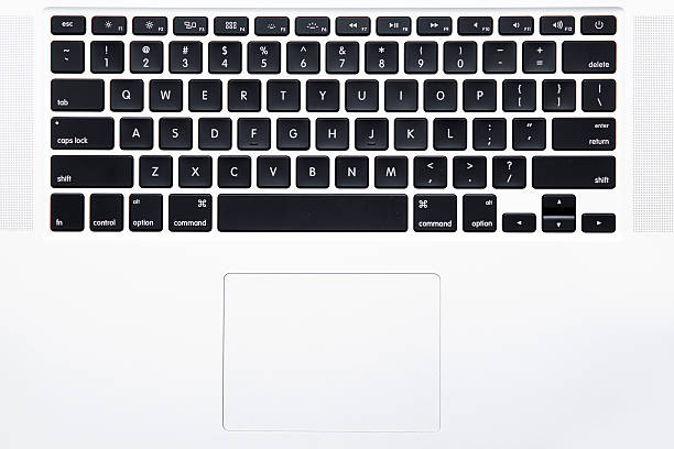 MacBook Pro keyboard New York City, U.S.A - April 15, 2015: Top view of the keyboard of Apple MacBook Pro Notebook Computer   It is a laptop computer that produced by Apple Inc.  apple keyboard stock pictures, royalty-free photos & images