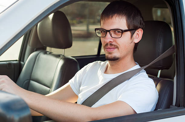 istock Male caucasian good driver is smiling in his car 471771032