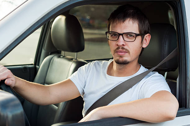 Male caucasian serious driver in a car stock photo