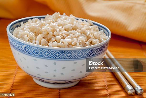 Brown Rice In Blue And White Pattern Bowl Stock Photo - Download Image Now - Blue, Bowl, Brown Rice