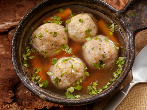 A classic favourite! Fluffy matzo balls floating in roasted chicken and herb broth.- Photographed on Hasselblad H3D2-39mb Camera