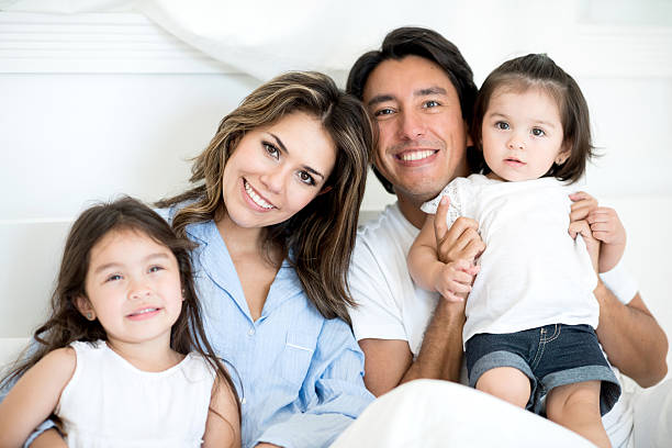 istock Happy Latin family in bed 471772448