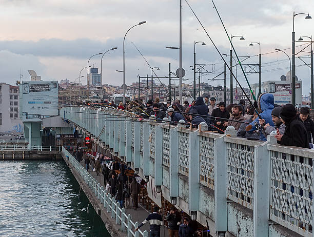 Big number of fishermen catch fish on Galata Bridge stock photo