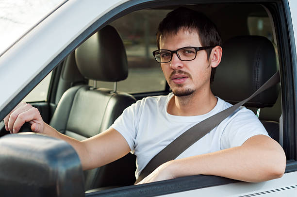 Male white serious driver in a car stock photo