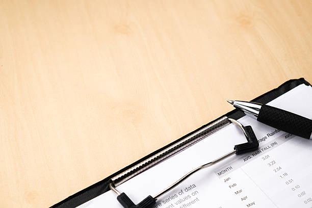 istock business and financial report with pen on wooden table.Document 471775676
