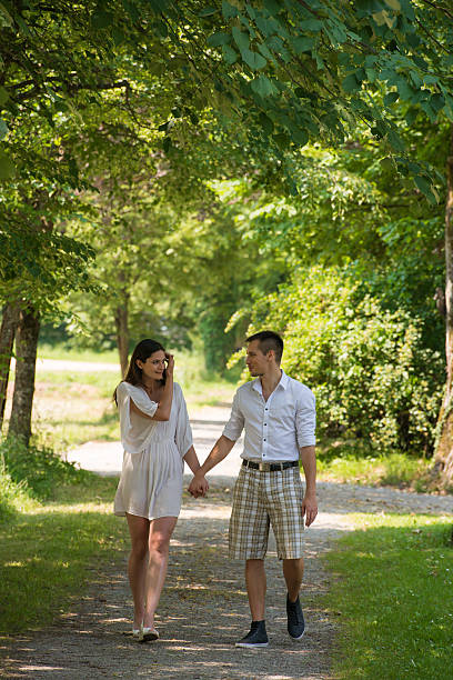 istock Happy young couple walking in park 471776107