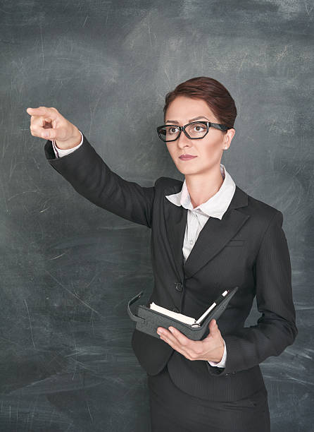istock Teacher with organizer pointing on someone 471776137
