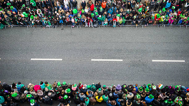 St. Patrick's Day Parade Crowds awaiting the beginning of the St. Patrick's Day Parade, Dublin city centre, Ireland.  parade stock pictures, royalty-free photos & images