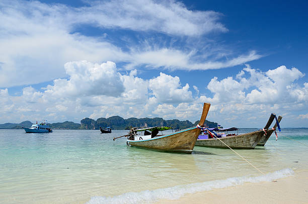 istock Group of long tail boat at the beach with island 471776730