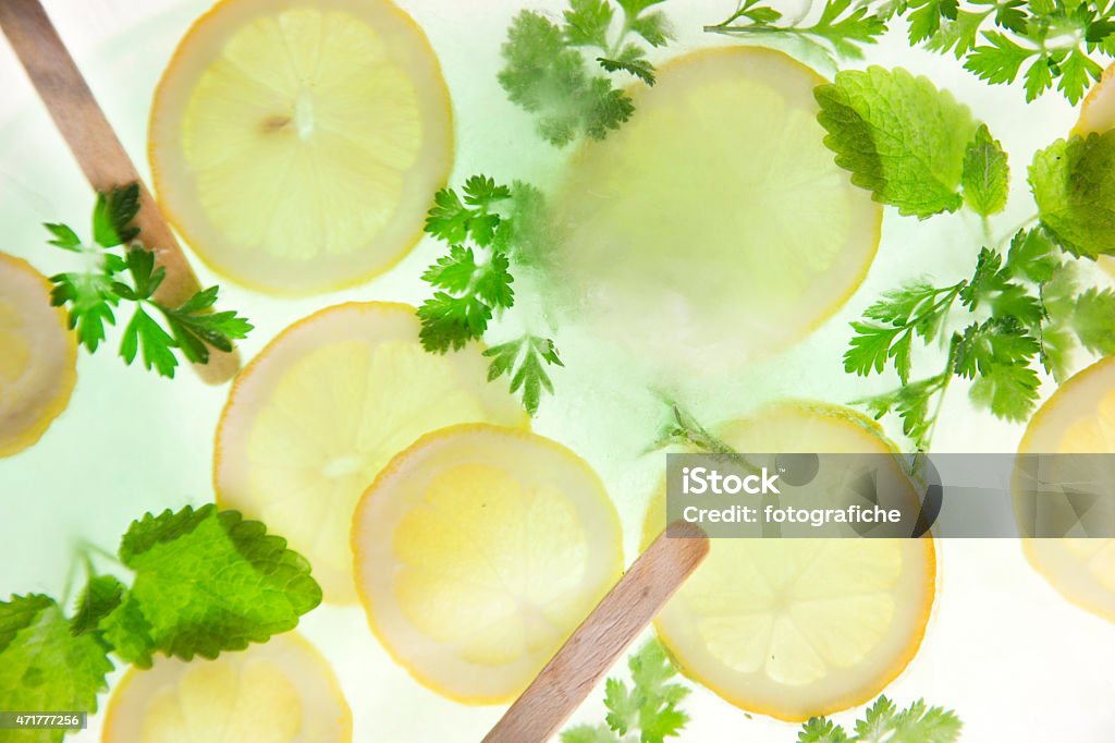 Lemon and mint Slices of lemon with mint leaves and sprigs of parsleySlices of lemon with mint leaves and sprigs of parsley 2015 Stock Photo
