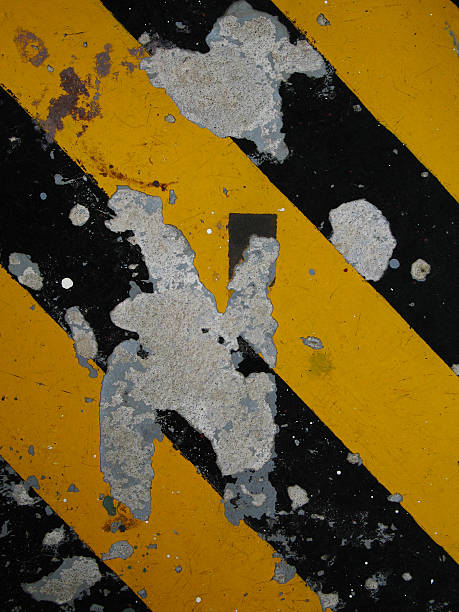 istock Concrete with chipped and peeling hazard striped paint 471778231