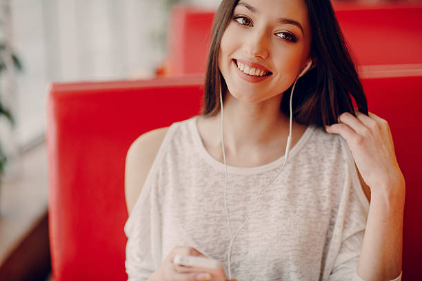 istock beautiful young girl enjoys phone and tablet 471778452