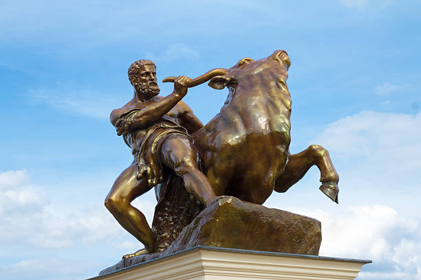 Heracles Taming The Creatan Bull Bronce-coated zinc sculpture (by A. Kriesmann, Berlin 1853) in the public garden of the Schwerin-Castle, Germany.  mythological character stock pictures, royalty-free photos & images