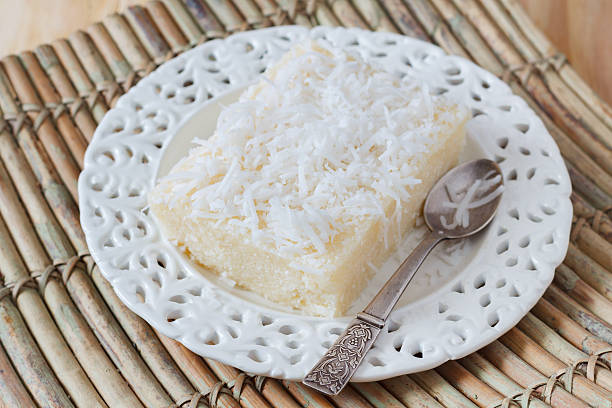istock Sweet couscous pudding  with coconut on white plate with spoon 471782126