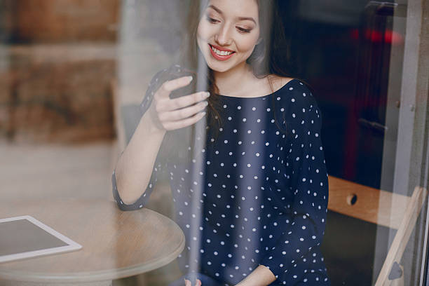 istock beautiful young girl enjoys phone and tablet 471782426