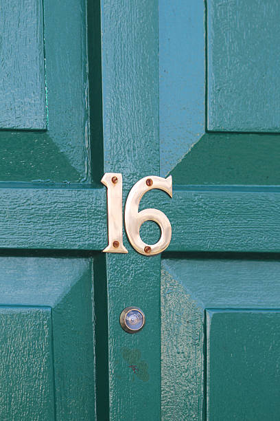 istock Green Door with bronze number 16 471783452