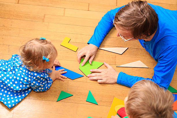 istock Teacher helping children with geometric shapes 471783752