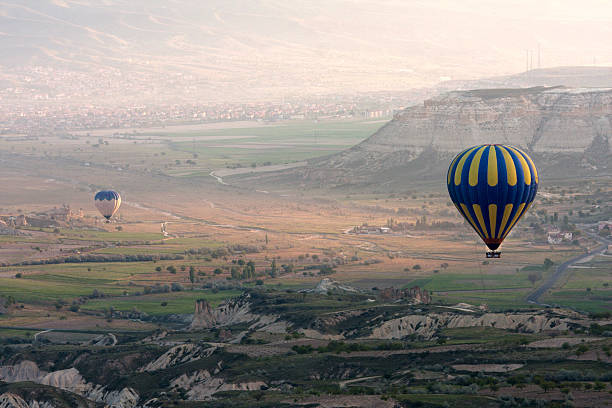 istock Hot air balloons rise over valley, Turkey 471784551