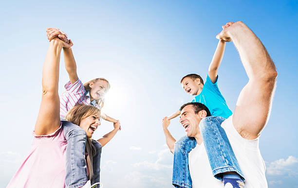 istock Parents carrying their children on shoulders. 471785783