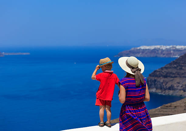 istock family looking at Santorini, Greece 471786397