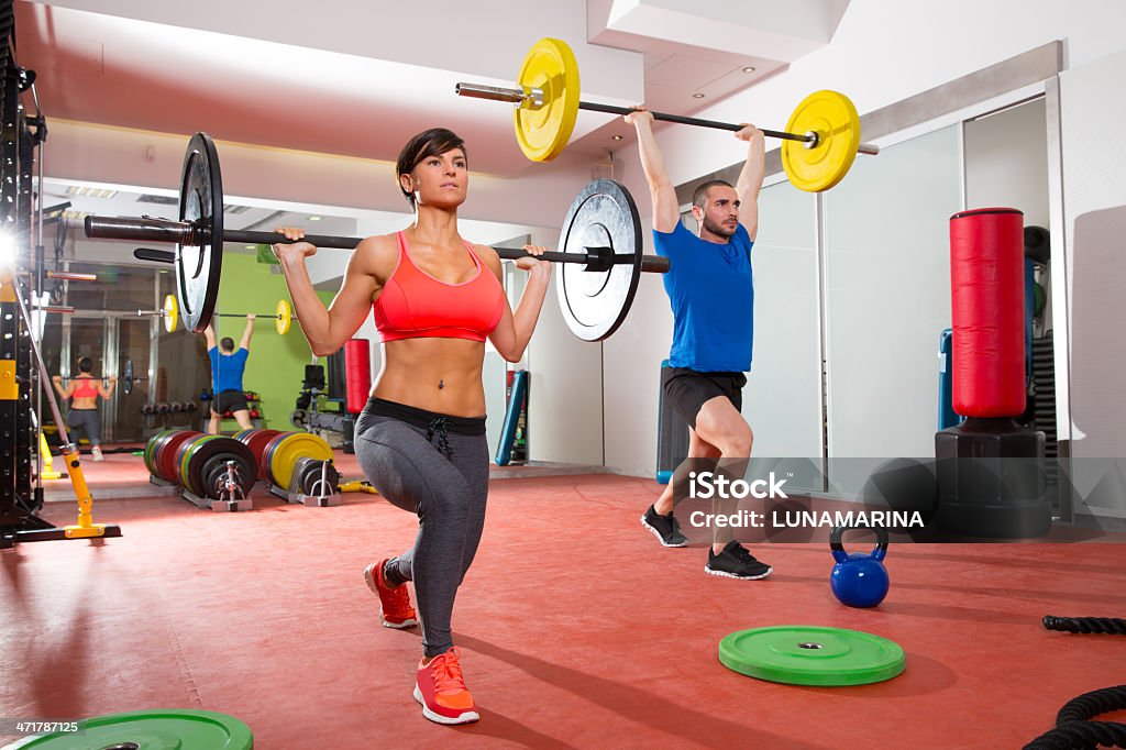 gym fitness gym weight lifting bar group gym fitness gym weight lifting bar by woman and man group workout 20-29 Years Stock Photo