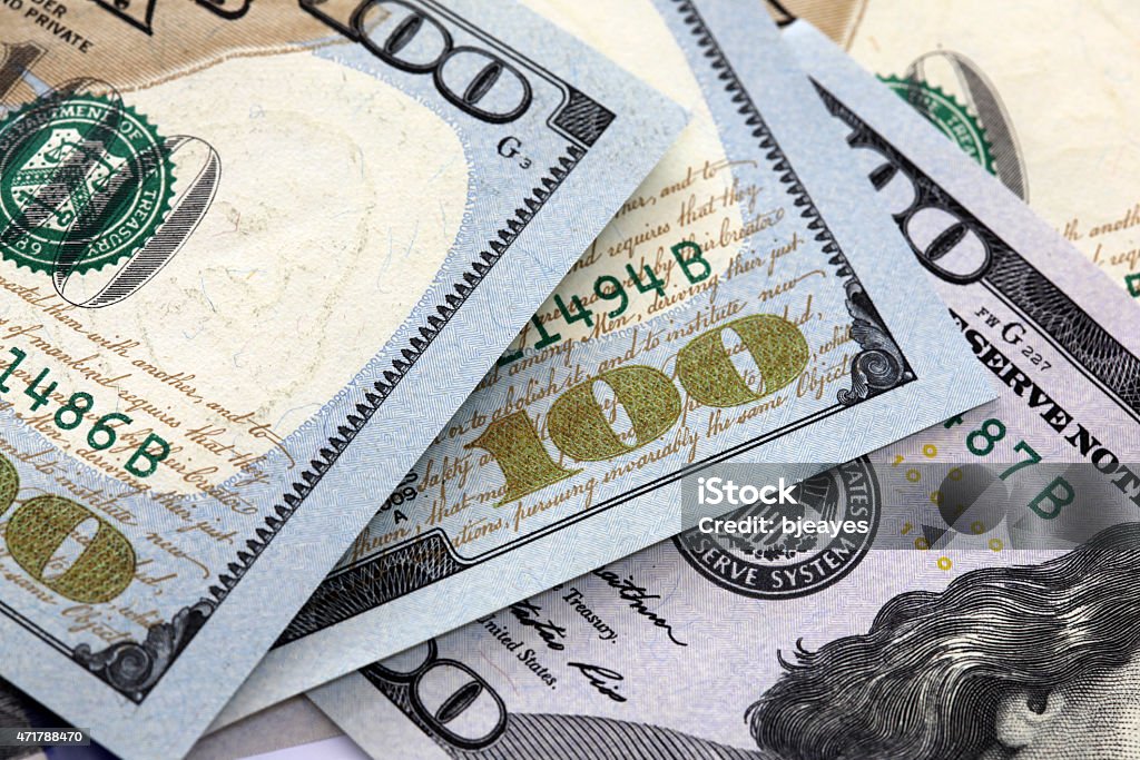 American Hundred Dollar Notes American one hundred dollar notes. Shallow depth of field focus  Detailed shot with no complete notes shown. 2015 Stock Photo