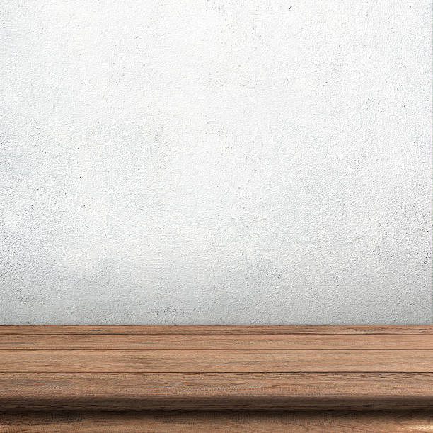 Wood table Vintage wood table in white cement wall. white shabby chic desk stock pictures, royalty-free photos & images