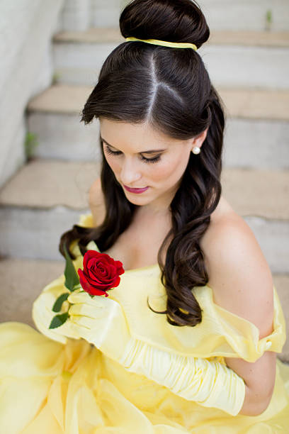 istock Beautiful Young Princess Looking at Her Red Rose 471790259