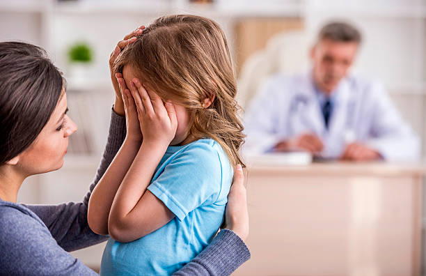 istock Mom with kid at the doctor. 471791216