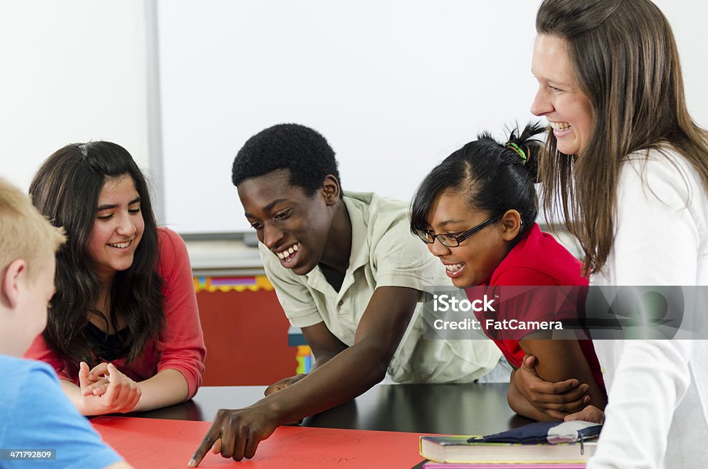 Group work Group of elementary school students working together on a project. Classroom Stock Photo