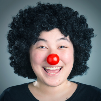 Woman clown makes a big smile