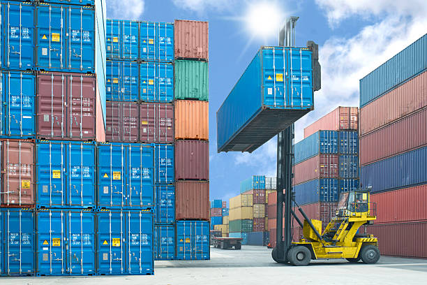 Forklift operator stacking shipping containers in the dock forklift handling container box loading to truck in import export logistic zone customs official stock pictures, royalty-free photos & images