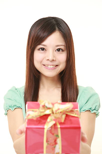 istock young Japanese woman offering a gift 471798506