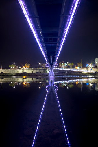 changpo bridge reflecting on the creek in gangneung taken at night.
