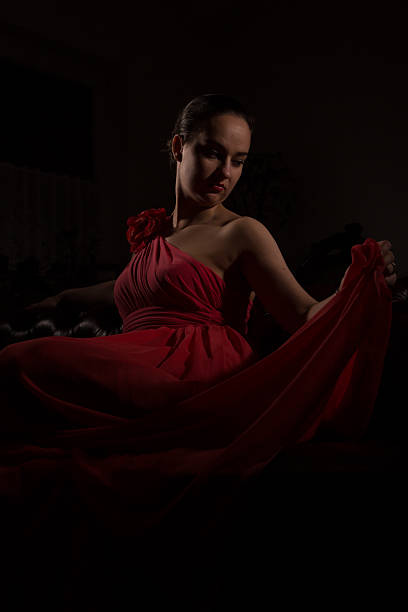 istock Lady in red in a dark room 471798806