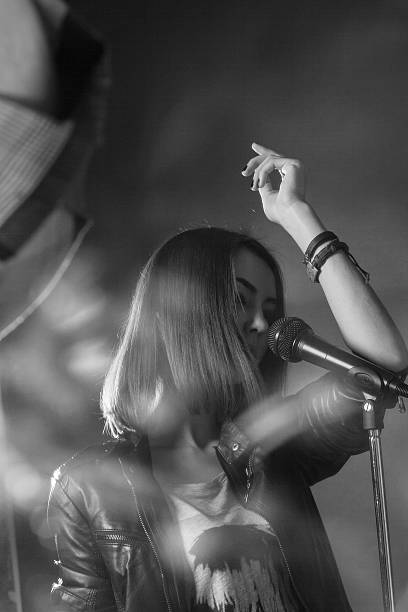 girl singing into a microphone in a studio
