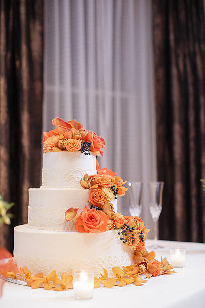 istock Wedding cake decorated with with Cymbidium orchids, Calla lilies, Viburnum 471799048