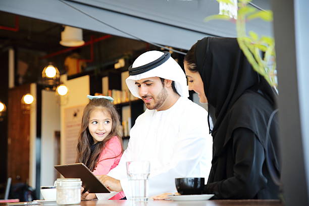 istock A happy young family using a digital tablet at a restaurant 471800142