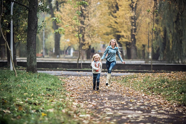 istock Mother with daughter in autumn park 471802846