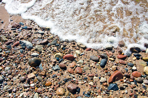 istock sea summer beach sand background with stones and wave 471803179