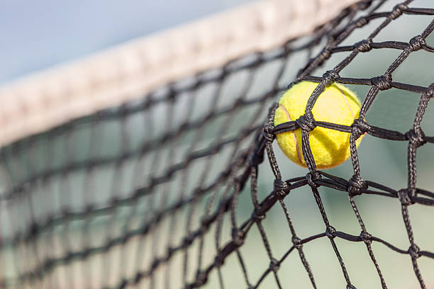 istock Tennis Ball on the Net 471803913