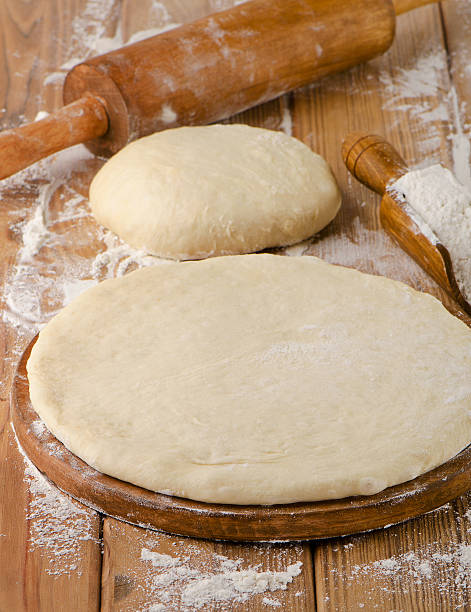 istock pizza dough on a wooden background 471804094