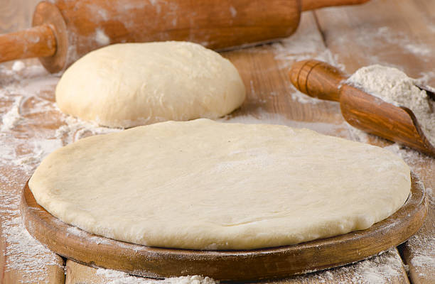 istock pizza dough on  wooden background 471804102