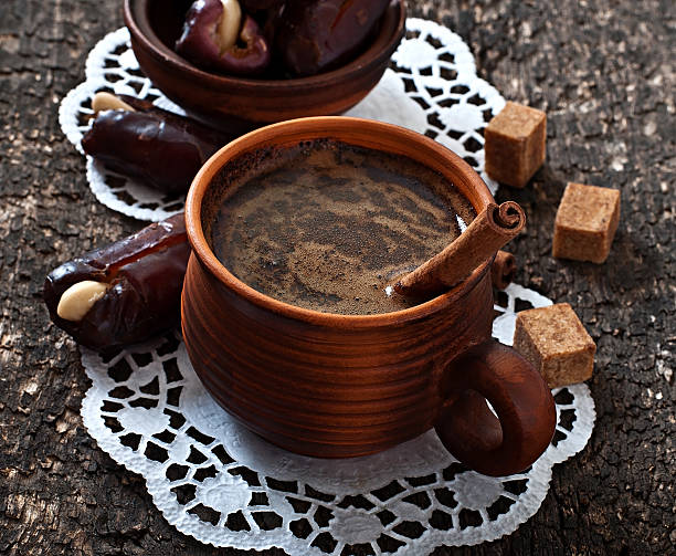 coffee and eastern dates on old wooden background