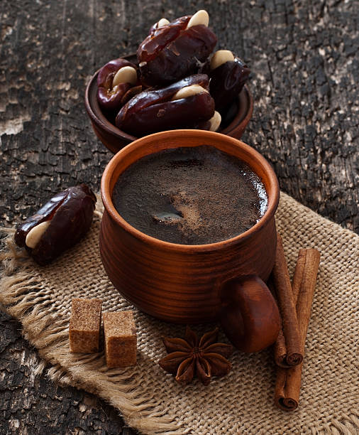coffee and eastern dates on old wooden background