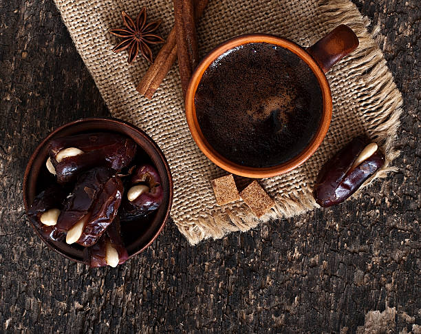 coffee and eastern dates on old wooden background