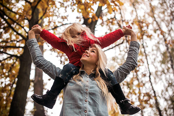 istock Mother with daughter in autumn park 471809120